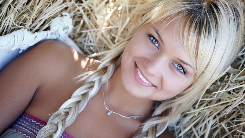 Woman with blue eyes on hay