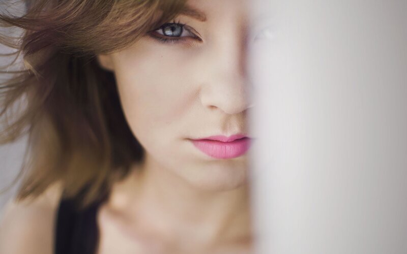 woman with blue eyes peeking