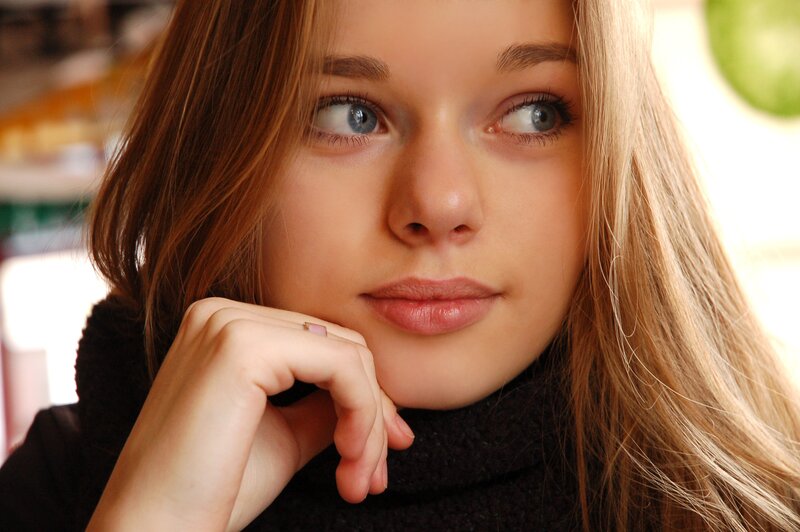 woman with blue eyes resting hand