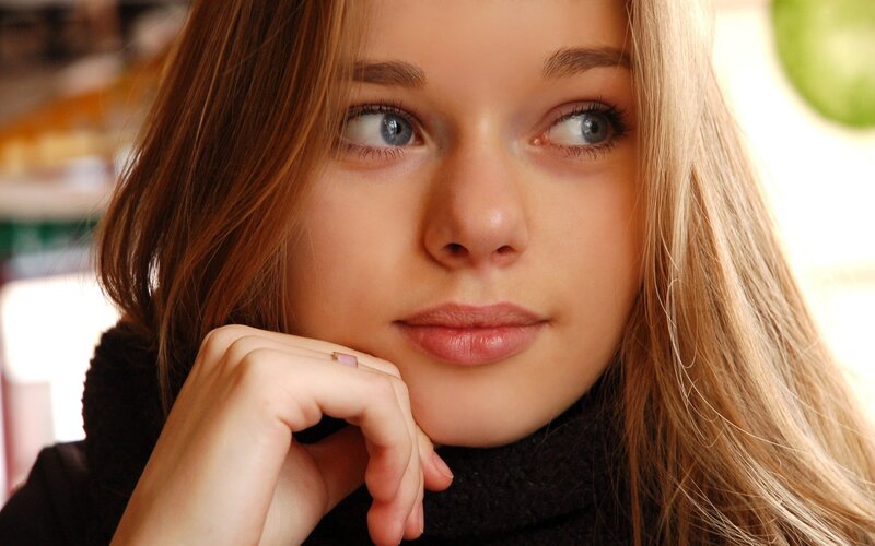 woman with blue eyes resting hand