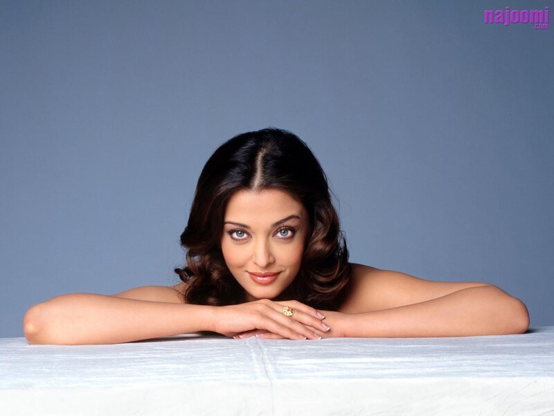 woman with blue eyes resting on table