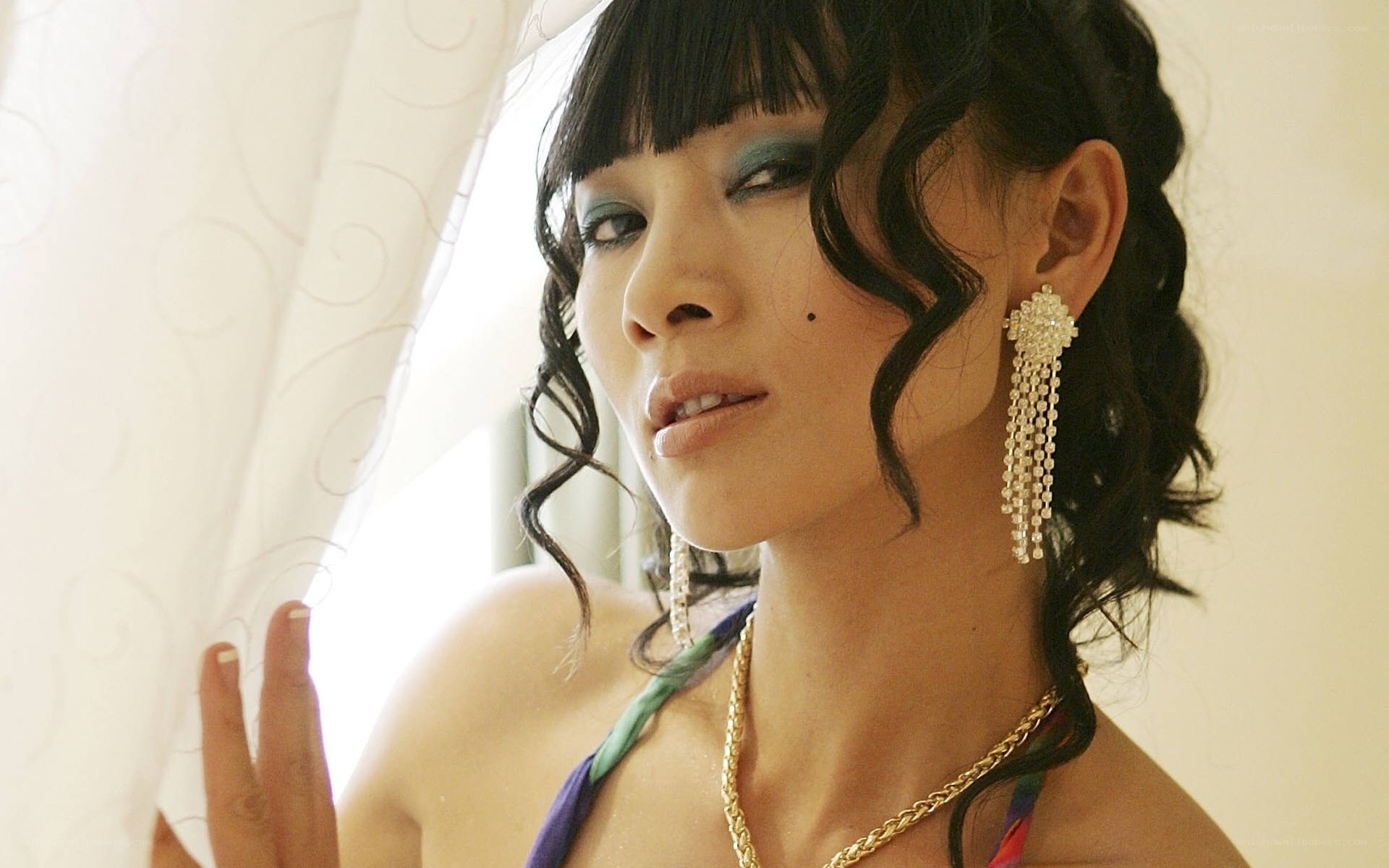 woman with blue eyeshadow and earrings