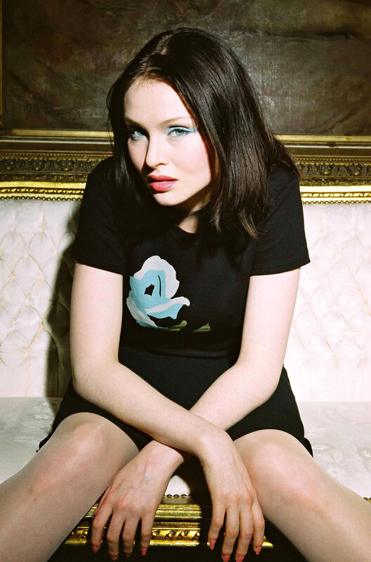 woman with blue eyeshadow sitting