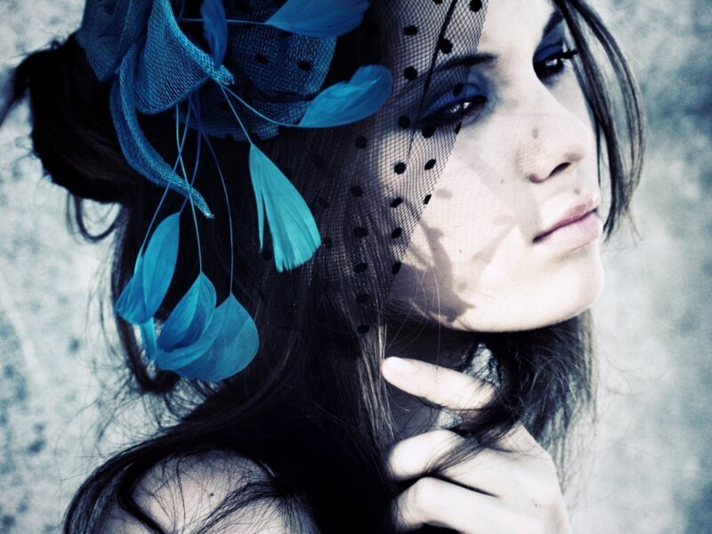 woman with blue feather headpiece