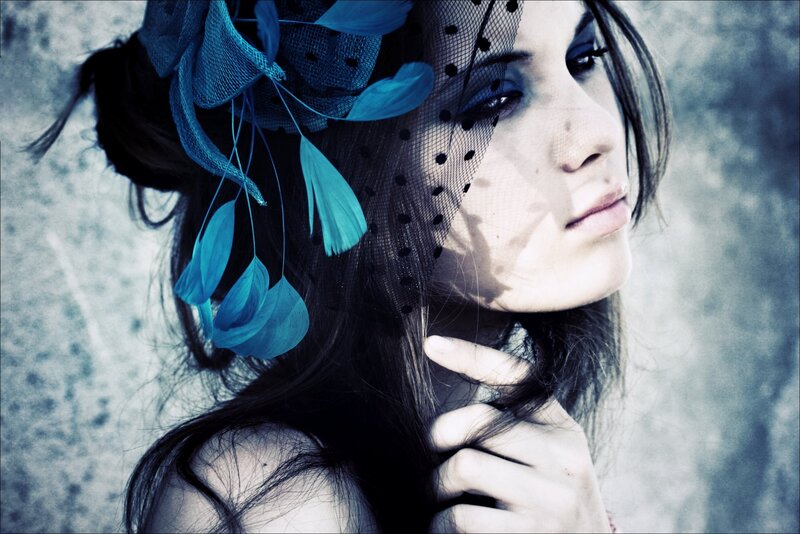 woman with blue feather headpiece