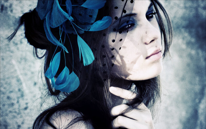 woman with blue feather headpiece