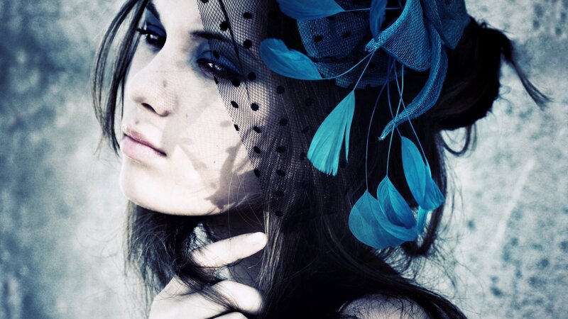 woman with blue feathered veil