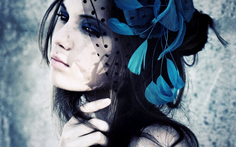 woman with blue feathered veil