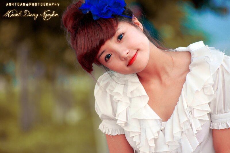woman with blue flower in hair