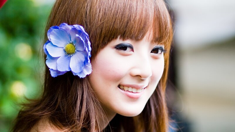 woman with blue flower in hair