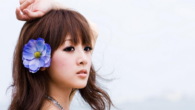 woman with blue flower in hair