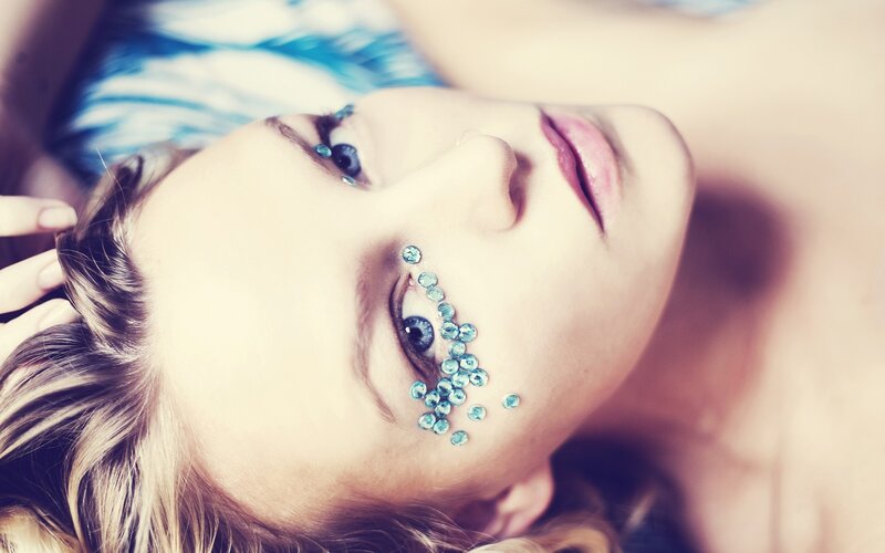 woman with blue gems on face