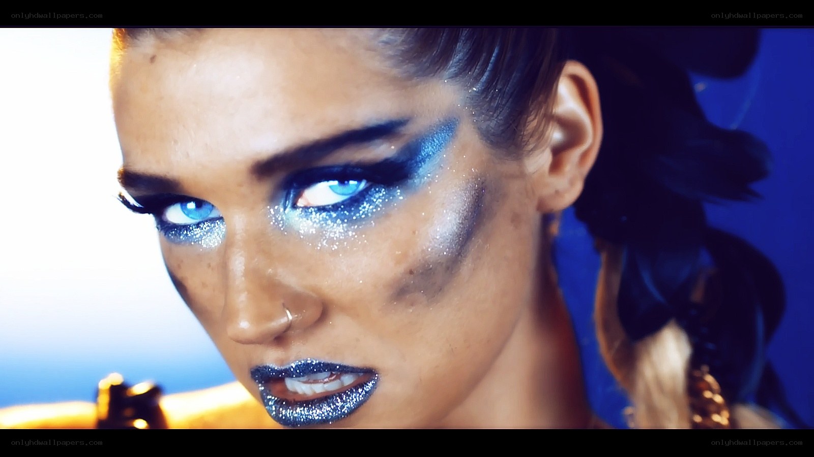 woman with blue glitter makeup