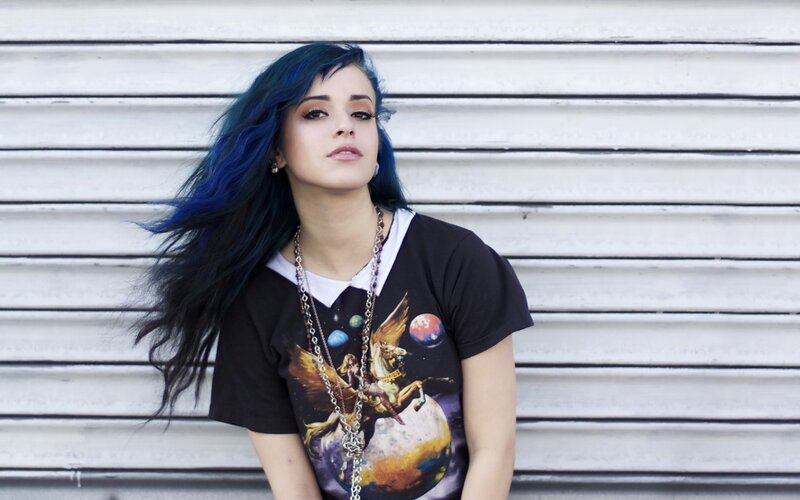 woman with blue hair against garage door