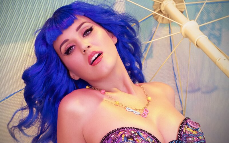 woman with blue hair and colorful outfit