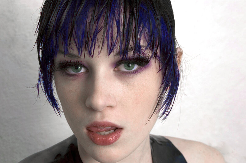 woman with blue hair and green eyes
