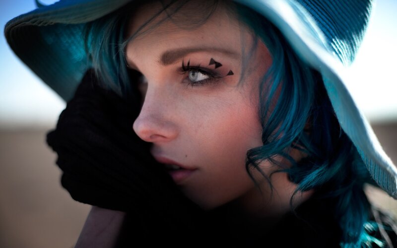 woman with blue hair and hat