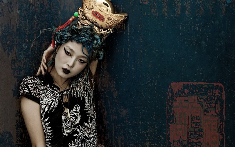 woman with blue hair and ornate headpiece