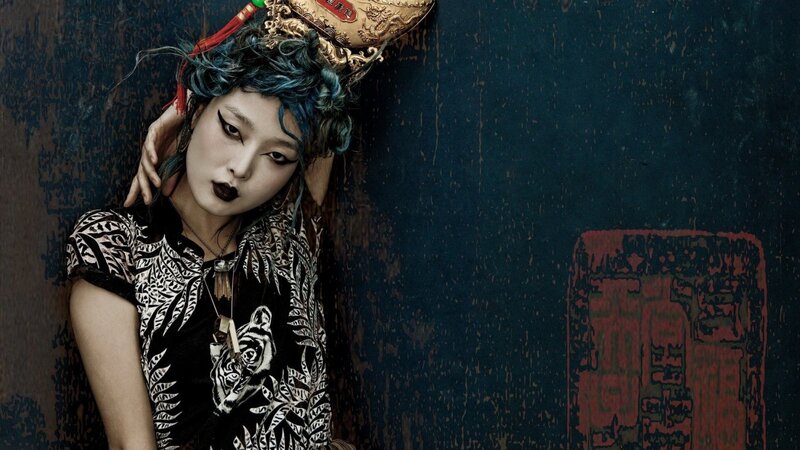 woman with blue hair and traditional headpiece
