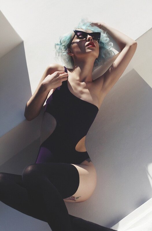 woman with blue hair in black bodysuit