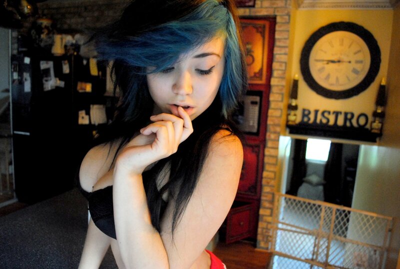 woman with blue hair in kitchen
