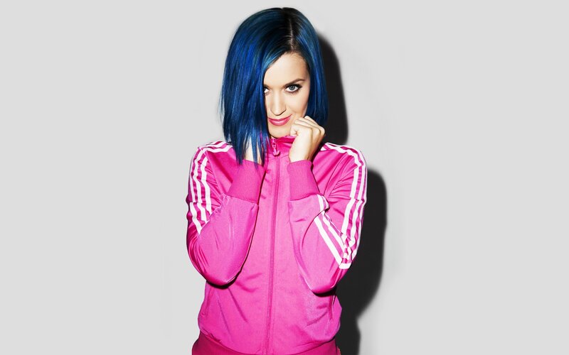 woman with blue hair in pink jacket