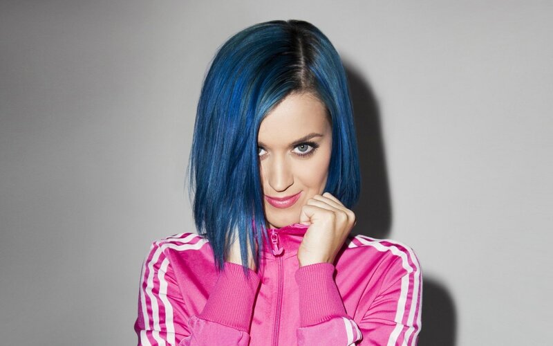woman with blue hair in pink jacket