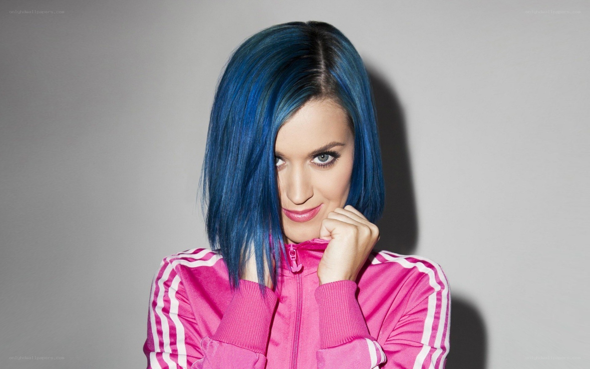 woman with blue hair in pink jacket