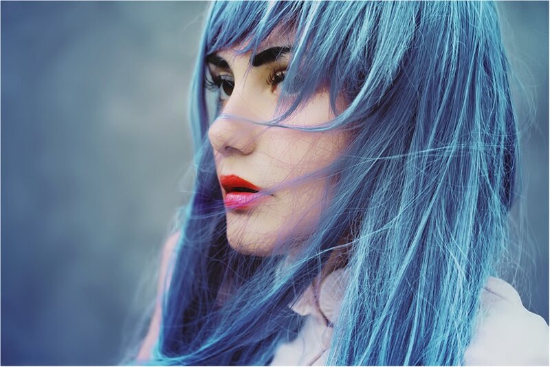 woman with blue hair in wind