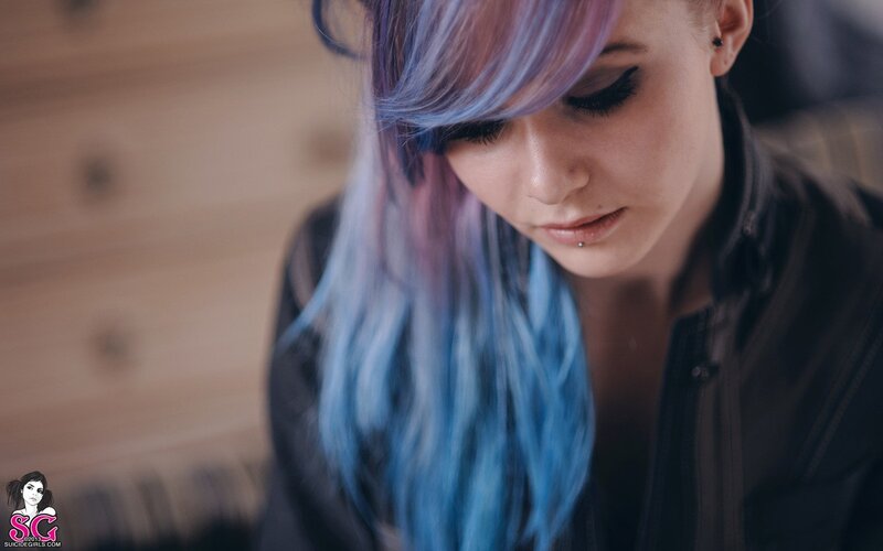 woman with blue hair looking down