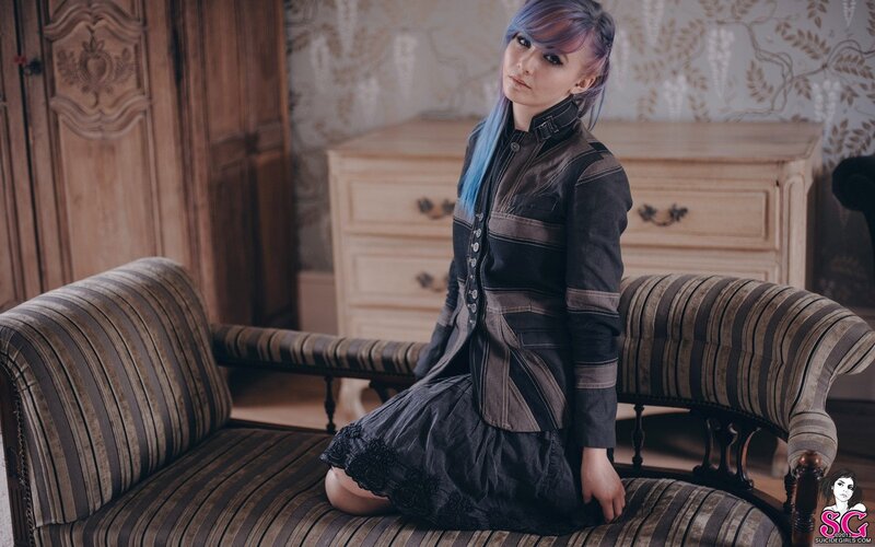 woman with blue hair on a sofa