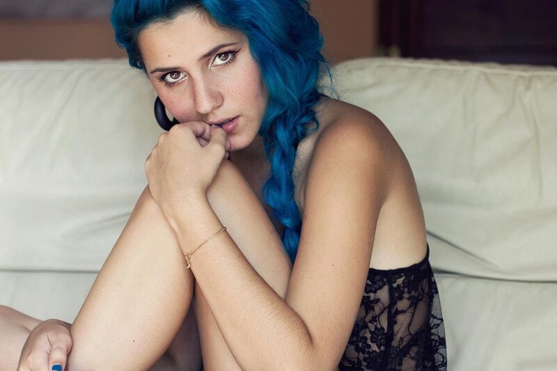 woman with blue hair on couch