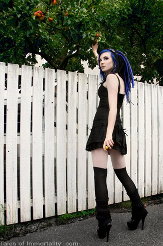 woman with blue hair picking apples