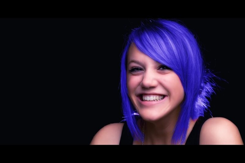 woman with blue hair smiling