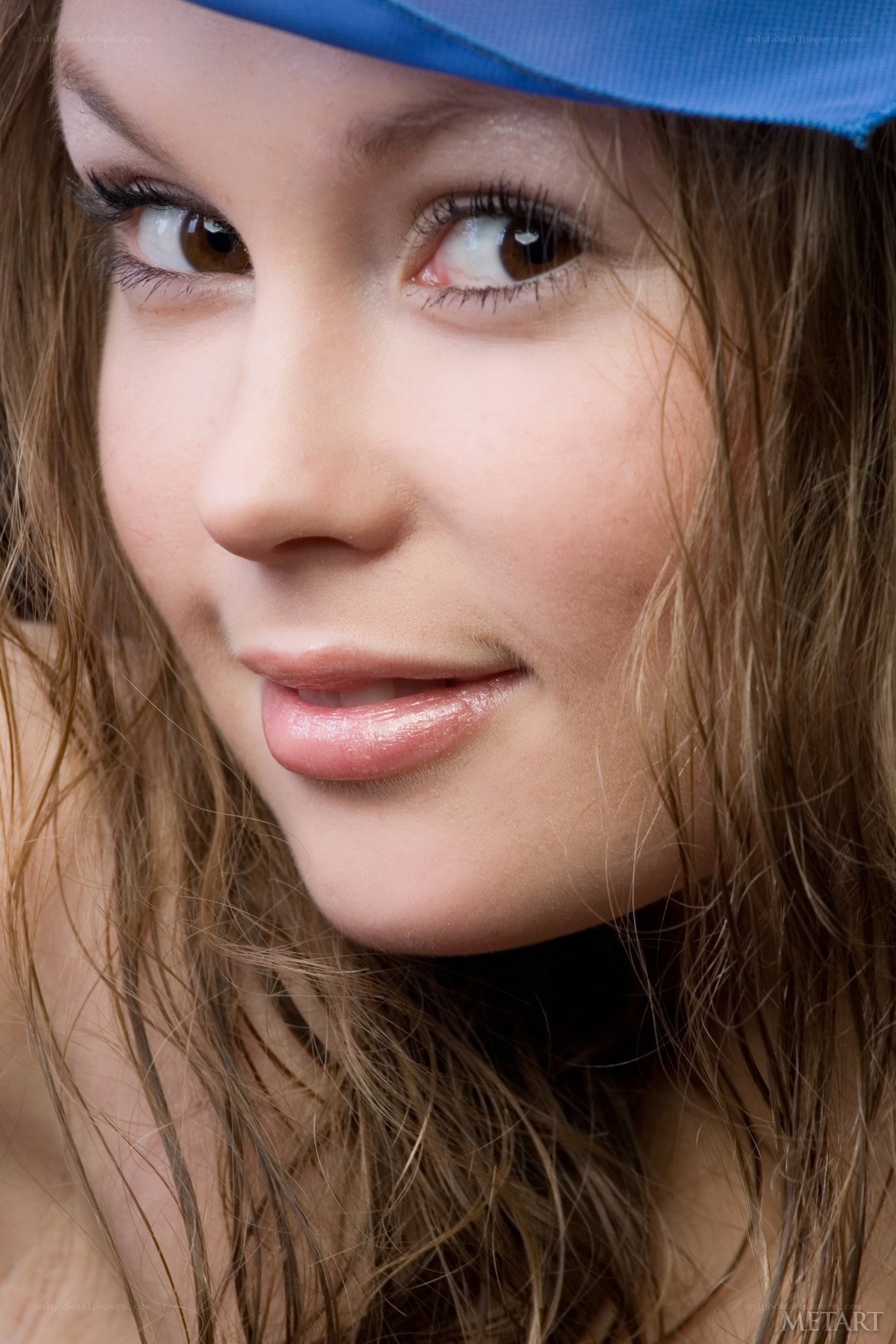 woman with blue hat smiling