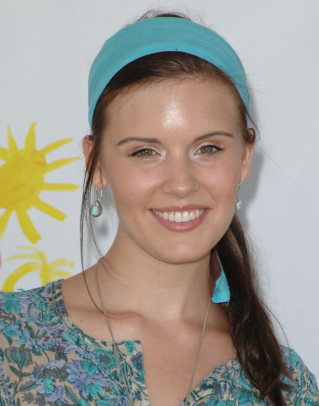 woman with blue headband smiling