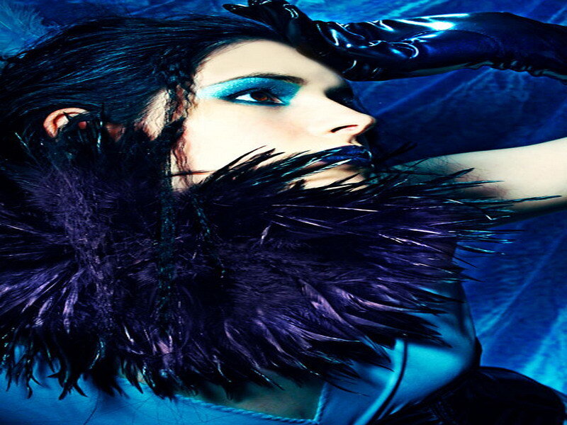 woman with blue makeup and feathers