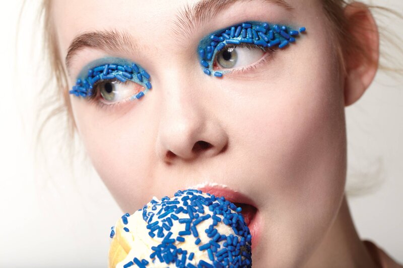 woman with blue makeup eating ice cream