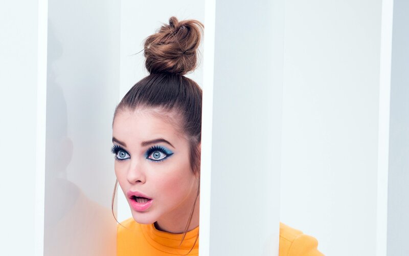 woman with blue makeup peeking