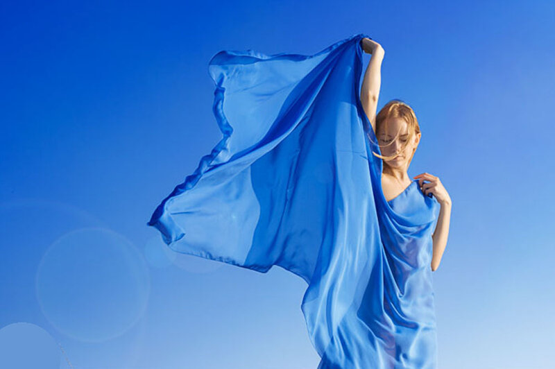 woman with blue scarf in sky