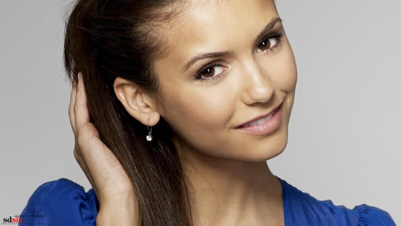 woman with blue top smiling