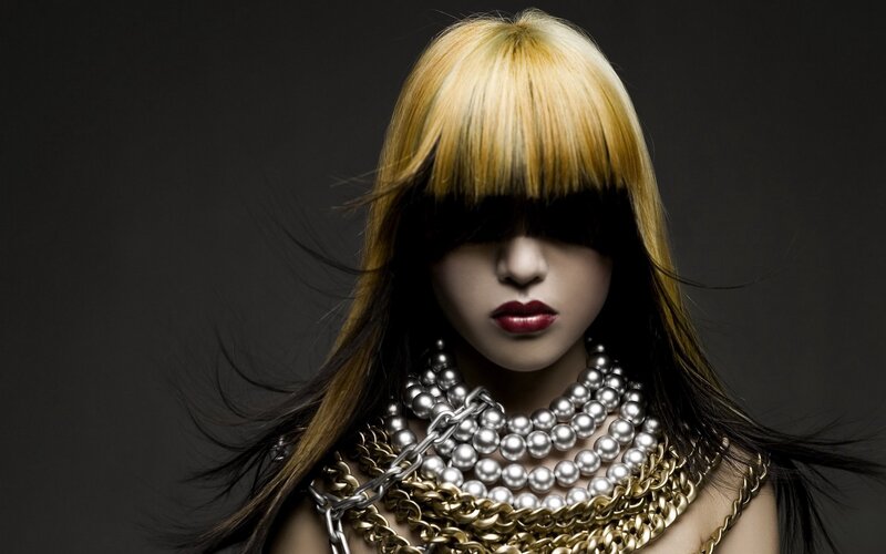 woman with bold hair and jewelry