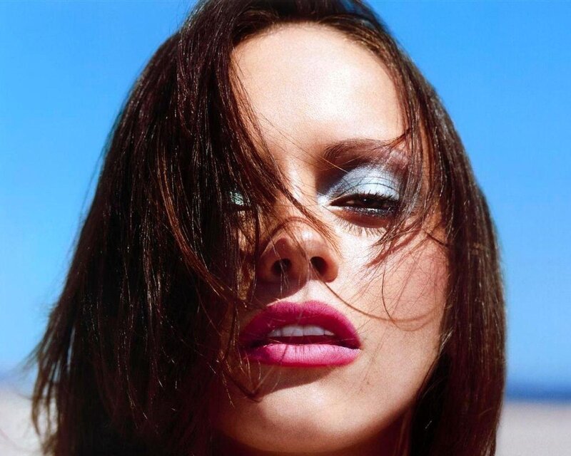 woman with bold makeup against blue sky