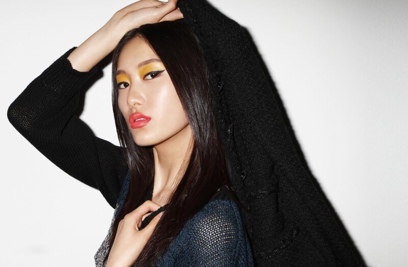 woman with bold makeup and black sweater