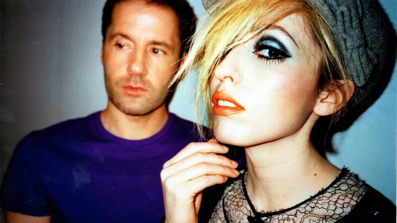 woman with bold makeup and man in purple