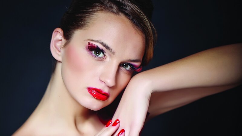 woman with bold makeup and red nails