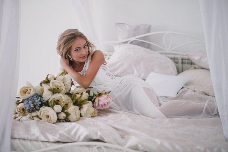 Woman with Bouquet on Bed