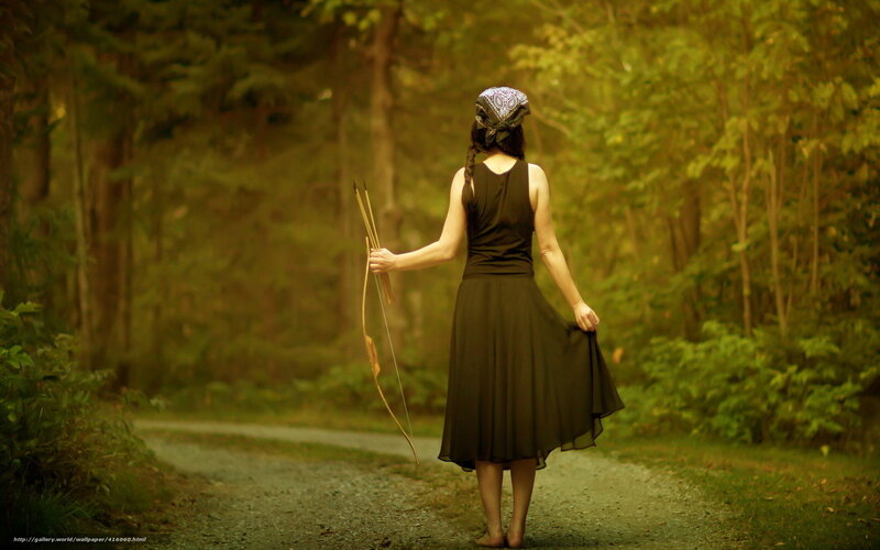 Woman with bow in forest