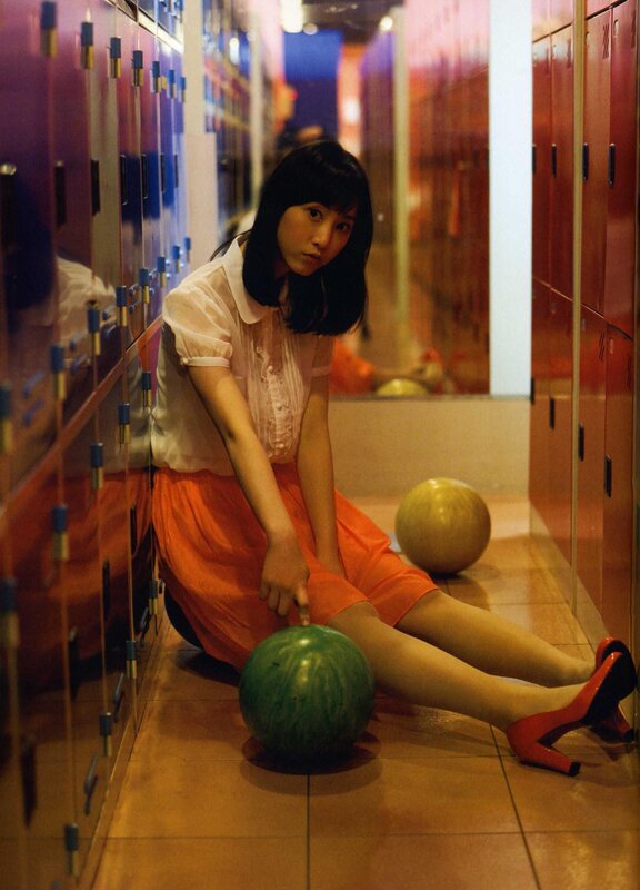 Woman with bowling balls in locker room
