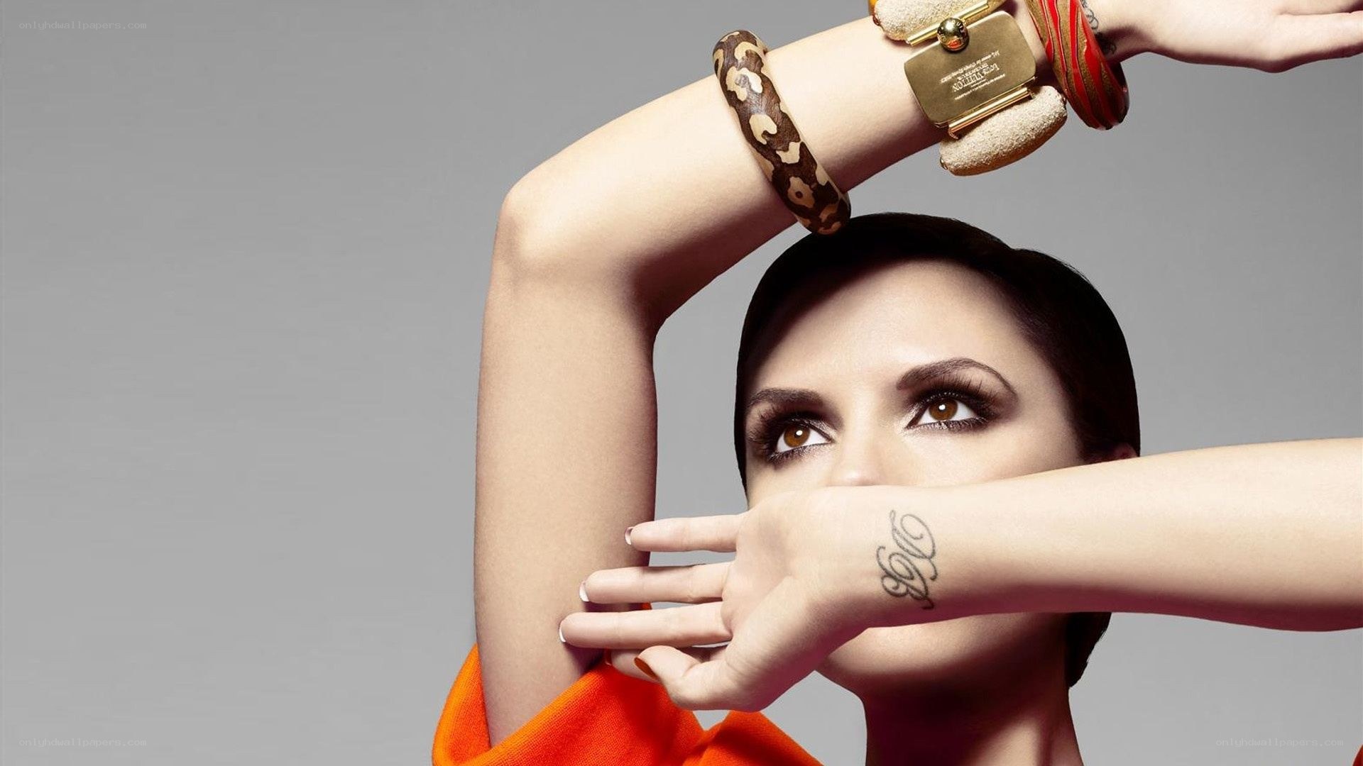woman with bracelets and tattoo